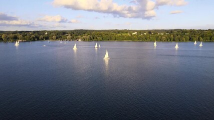 Canvas Print - Sailboat on lake Starnberg. Munich residents and vacationers sail and relax on the idyllic mountain lake in Bavaria. Aerial view from drone