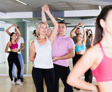 Glad Active Different Ages People Having Dancing Class In Classroom