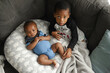 © Creative Flame - Black boys, siblings, sitting and laying on sofa