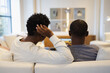 © Creative Flame - Rear view of Black couple sitting on sofa