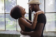 © Creative Flame - Young couple standing by window and embracing