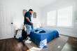 © Creative Flame - African American man with prosthetic leg doing chores, laundry, at home