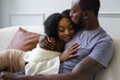 © Creative Flame - Black Couple hugging on sofa, comfortable