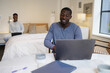 © Creative Flame - Black Couple using laptops in bedroom