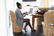 © Creative Flame - Black woman working from home on virtual meeting video chat