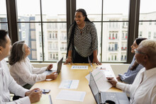 Mid Black Woman Leading Business Team Meeting