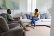 © Creative Flame - Black couple has conversation in family room, military