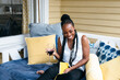 © Creative Flame - Black woman laughing, drinking wine, stay-cation