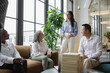 © Creative Flame - Business team meets in office, Middle Eastern woman leadership