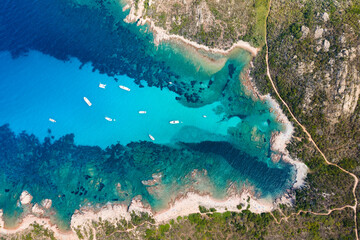 Canvas Print - View from above, stunning aerial view of a green and rocky coastline bathed by a turquoise, crystal clear water. Costa Smeralda, Sardinia, Italy.