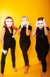 © Marina Chernivetskay - girls in white masks and white gloves in the image of mimes an unseen wall show hands actors of theater and cinema, the concept of advertising a shopping center