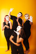 © Marina Chernivetskay - girls in white masks and white gloves in the image of mimes an unseen wall show hands actors of theater and cinema, the concept of advertising a shopping center