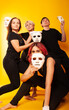 © Marina Chernivetskay - girls in white masks and white gloves in the image of mimes an unseen wall show hands actors of theater and cinema, the concept of advertising a shopping center