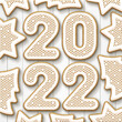 Christmas gingerbread cookies with the date 2022 on a white background. New year greeting card. View from above. Christmas vacation. Xmas festive holiday.