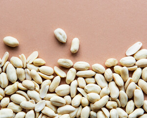 Canvas Print - Peeled peanuts on a brown background