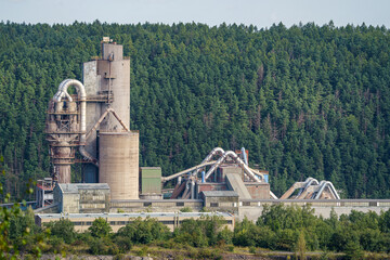 Opencast mining quarry with machinery and mining equipment. Limestone mining for cement production.