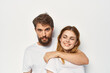 © SHOTPRIME STUDIO - cheerful young couple in white t-shirts friendship lifestyle light background