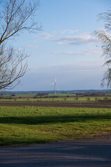 Wall Mural - Single wind turbine on flat farmlands of Skåne Sweden during spring