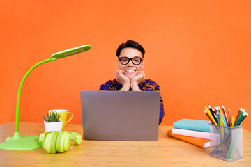 Sticker - Photo of dreamy sweet teen boy wear plaid outfit spectacles arms cheeks working modern gadget isolated yellow color background