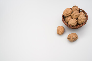 Sticker - Close up of wicker basket with Stack Walnuts isolated on a white