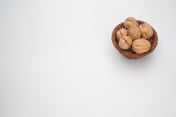 Sticker - Close up of wicker basket with Stack Walnuts isolated on a white