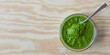 Bowl with green chutney sauce dip from coriander leaves. Top view with copy space.