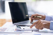 © crizzystudio - Accountant doing finance and calculate about cost on the desk at home office, close up hands of accountant using calculator count balance of the company.Calculating Bills With Calculator In Office