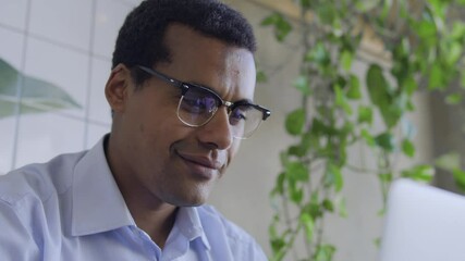 Handsome biracial man smiling chatting on dating web-site, spending time online