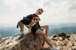 © Victoriya Bulyha - sporty young woman with a dog on top of the mountain