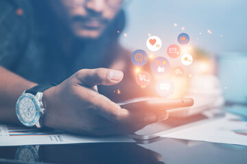 Businessman showing online trading social media market on mobile phone with notification icons such as stock trading, likes, messages, comments and on screen via smartphone.