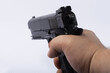 A man's hand shoots a pistol. Pistol on white isolated background. 