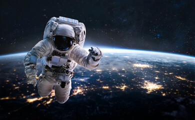 Leinwandbilder - Astronaut in outer deep space on orbit of Earth planet. Dark space and spaceman.Earth at night. Elements of this image furnished by NASA
