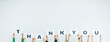 © Bangkok Click Studio - Studio shot of unrecognizable unidentified group of staff officer in corporate office holding thank you alphabet cardboard paper sign over head showing appreciation to customer on white background