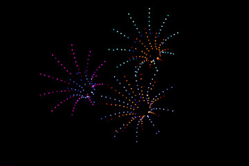 photo of colorful bokeh these drone light shows could replace fireworks on night sky background. made fireworks by drones