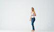 © SHOTPRIME STUDIO - woman in jeans barefoot stands on the floor fashion emotions motion