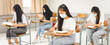 © EduLife Photos - Asian college students back to school with facemask and keep social distance while study in the classroom to prevent COVID-19 pandemic
