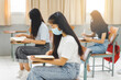 © EduLife Photos - Asian college students back to school with facemask and keep social distance while study in the classroom to prevent COVID-19 pandemic