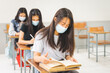 © EduLife Photos - Asian college students back to school with facemask and keep social distance while study in the classroom to prevent COVID-19 pandemic