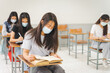 © EduLife Photos - Asian college students back to school with facemask and keep social distance while study in the classroom to prevent COVID-19 pandemic