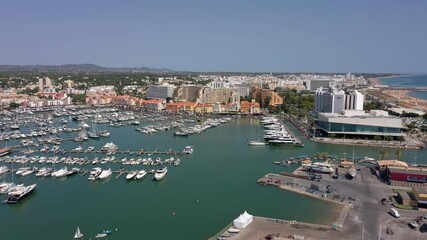 Canvas Print - Aerial video of the tourist Portuguese town of Vilamoura, with views of the beaches and docks for luxury yachts, hotels and restaurants. Portugal, Algarve.