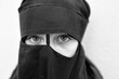 Portrait of a little girl in a niqab on a white background