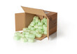 © Maryia - Shipping peanuts spilling out of the parcel box laying on its side, isolated on a white. Brown cardboard box with loose green foam fillers to protect fragile parcels in transit. Polystyrene pellets.