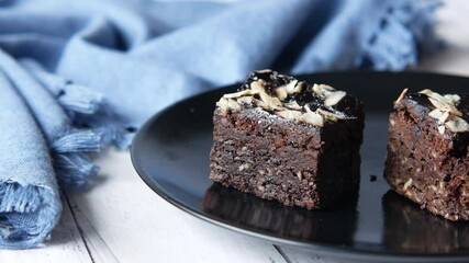 Wall Mural - cutting slice of brownie with fork on plate on table 