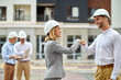 © zinkevych - Two colleagues in safety helmets greeting each other