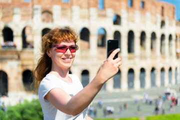 Wall Mural - Selfie of girl tourist at Colosseum (Coliseum), Rome, Italy. Travel concept.