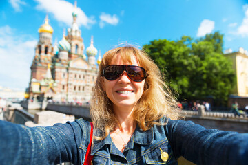 Wall Mural - Girl tourist takes selfie in Saint Petersburg, Russia, Europe. Travel concept.