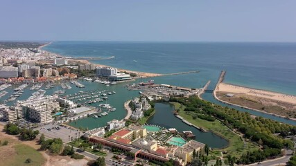 Canvas Print - Aerial video of the tourist Portuguese town of Vilamoura, with views of the beaches and docks for luxury yachts, hotels and restaurants. Portugal, Algarve.