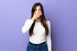 © luismolinero - Teenager Brazilian girl over isolated purple background covering mouth with hand