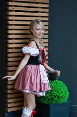 Wall Mural - Young beautiful woman with glass of beer. Oktoberfest 2021 concept.