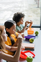 Wall Mural - multiethnic children eating sandwiches for lunch in school